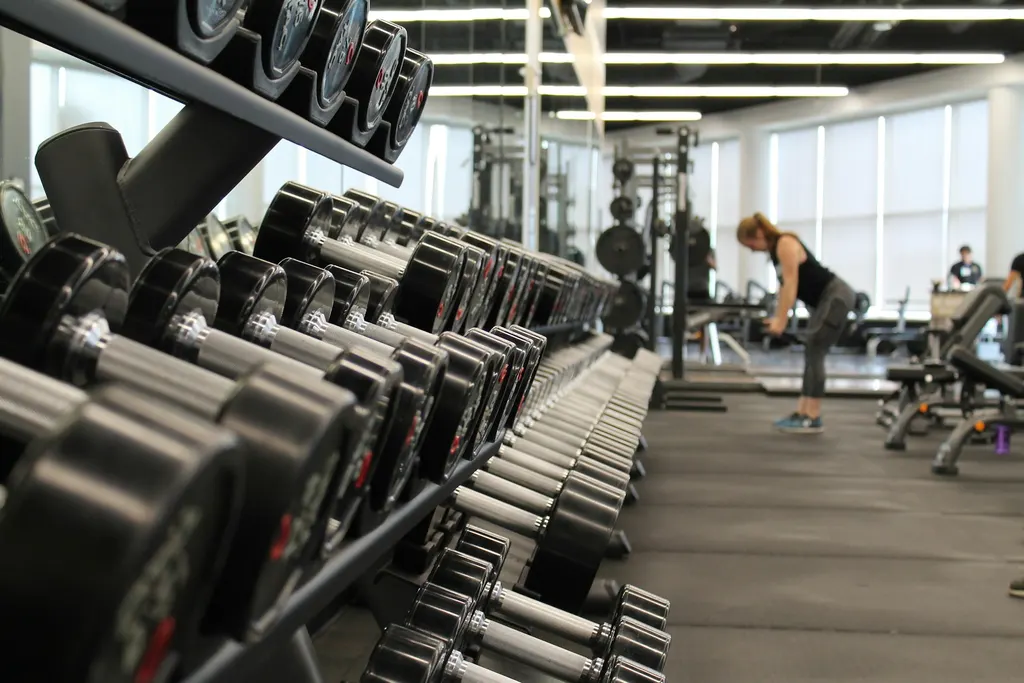 Heavy iron barbells under dramatic gym lighting
